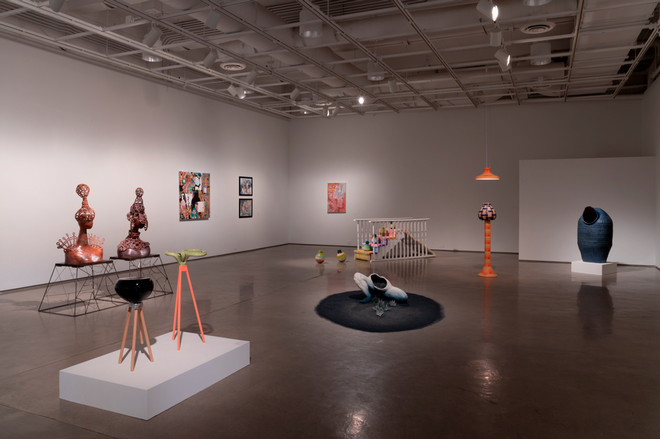 art gallery showcasing various sculptures and paintings