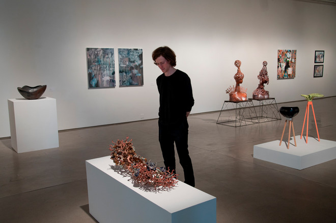 patron viewing various sculptures