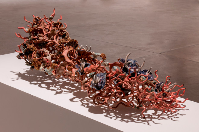 vibrant sculpture composed of an assortment of colored objects