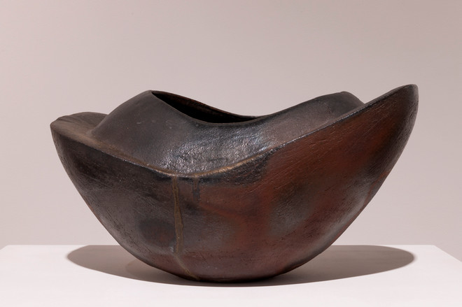 close-up view of a brown and black vase-like sculpture