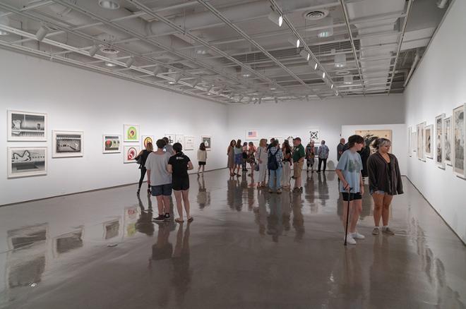 gallery space filled with people looking at the artwork on display
