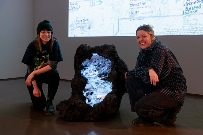 Artists posing with their artwork