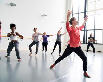 students following an instructor in the dance studio