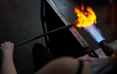 torching fire over glass that's molten