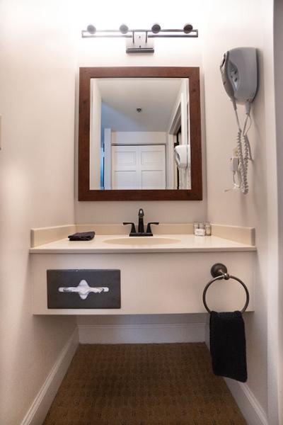 accessible sink, countertop, and mirror in bathroom