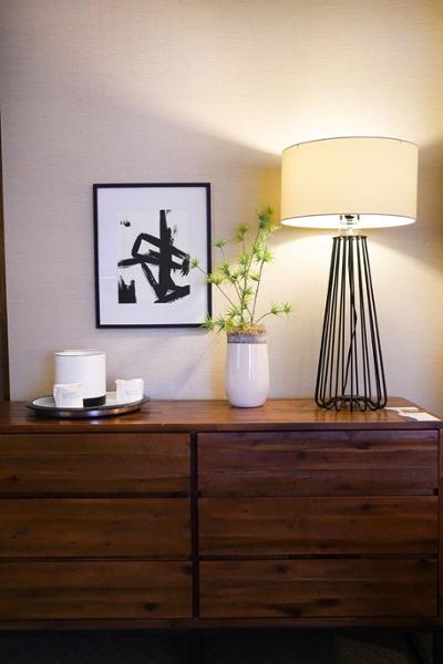 dresser with modern lamp and artwork