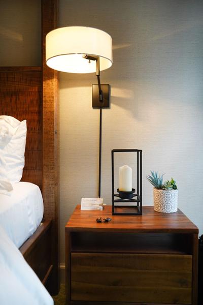 bedside table with reading lamp and art