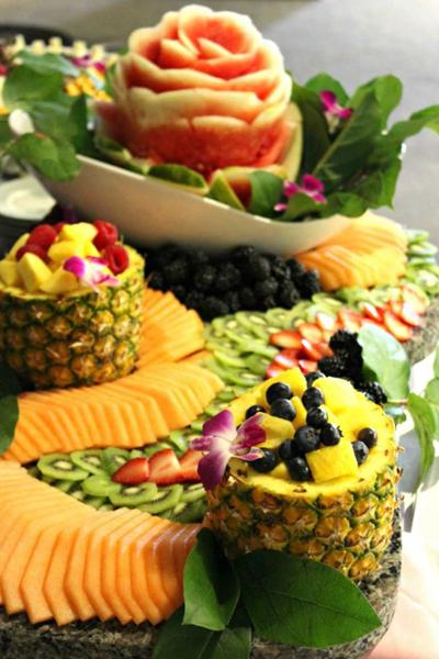 various types of carved fruit on a table laid out beautifully