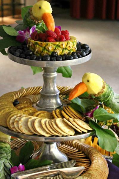 carved fruit on a three tier platter with crackers