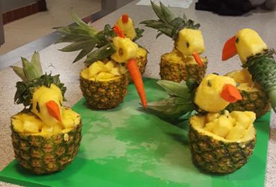 carved pineapples in the shape of toucans