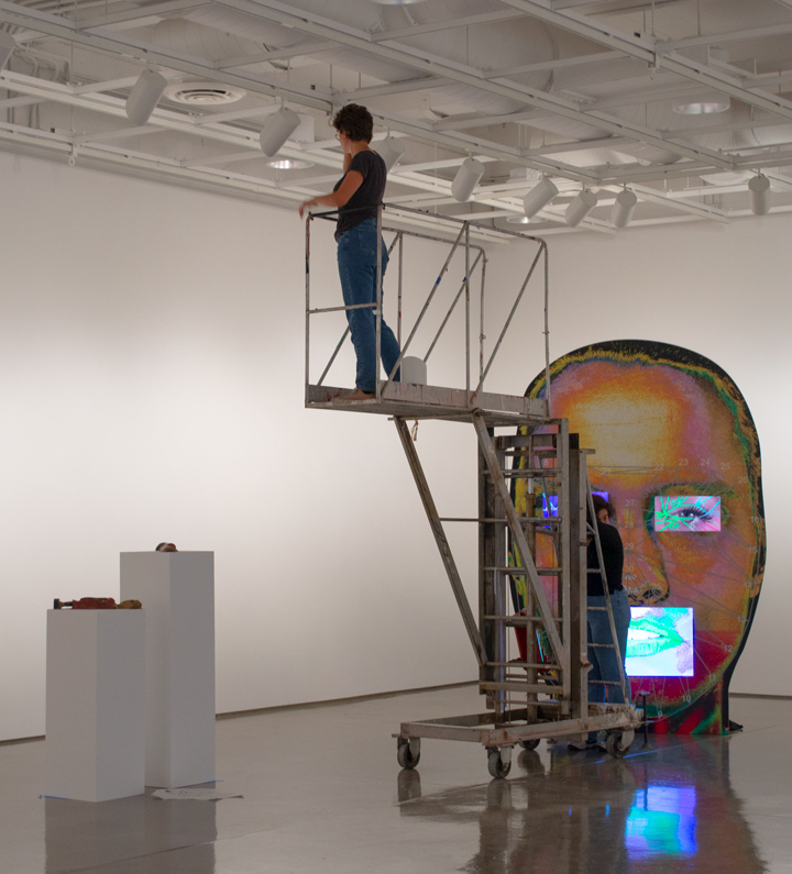 students working on the lighting of an exhibit behind the scenes