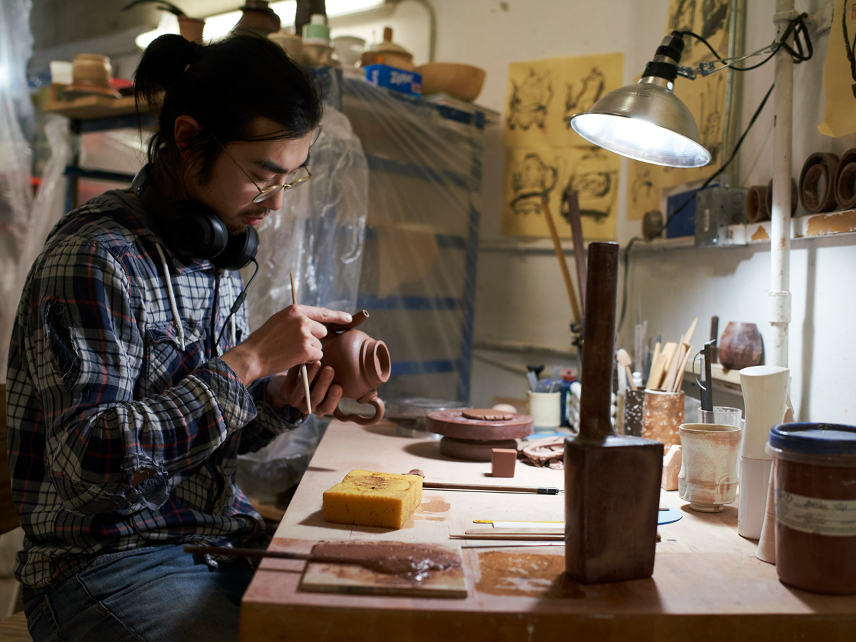two people talking in front of a painting