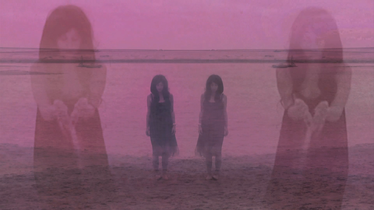 video still with heavy pink hue