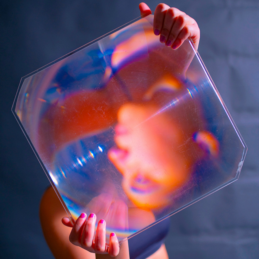 glass reflecting a person with hues of pink and blue