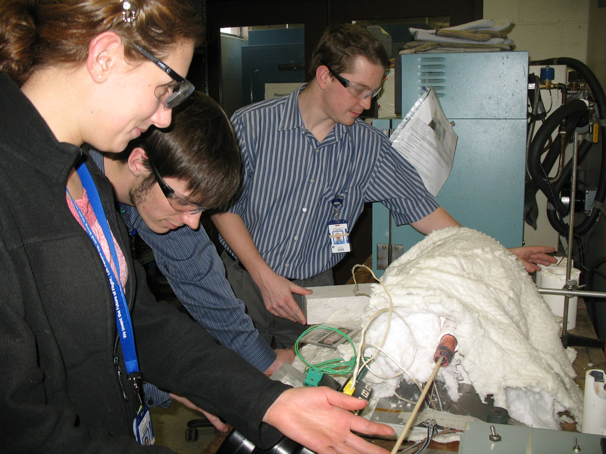Three internship students working on a project
