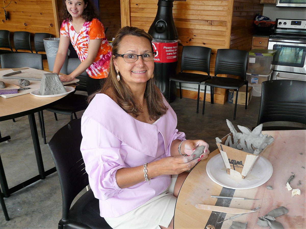 Student at clay workshop working with clay