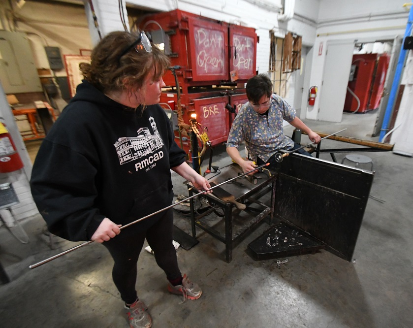 community member working with glass artist