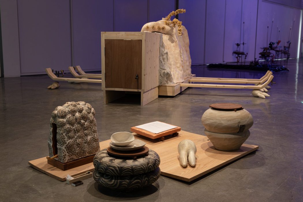 More abstract sculptures made from various materials in an open installation space.