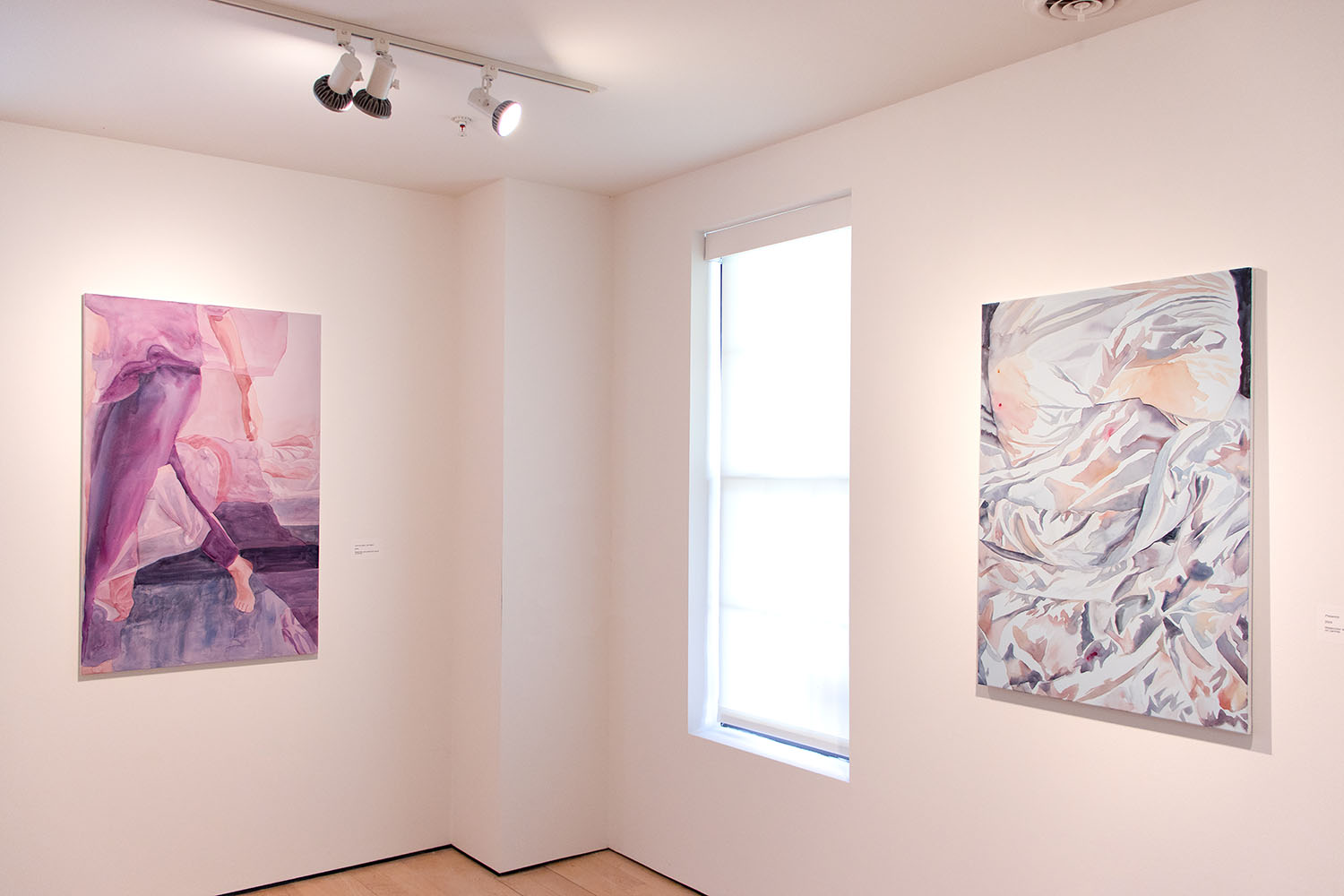 Abstract gallery painting with purple and pink hues featuring a figure, next to a beige-toned artwork resembling crumpled fabric