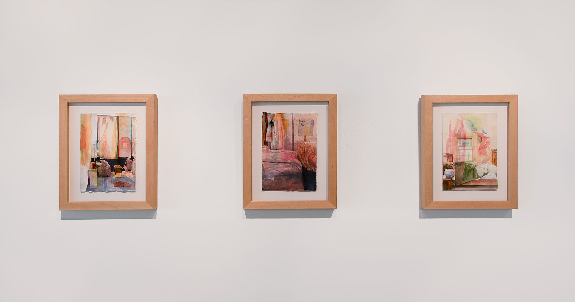 Three abstract interior paintings in warm tones displayed side by side.