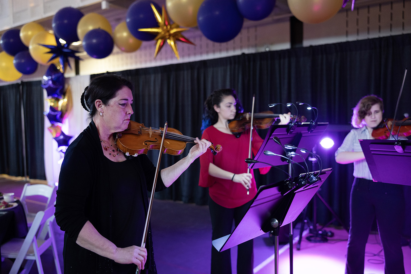 Faculty and students playing string instruments