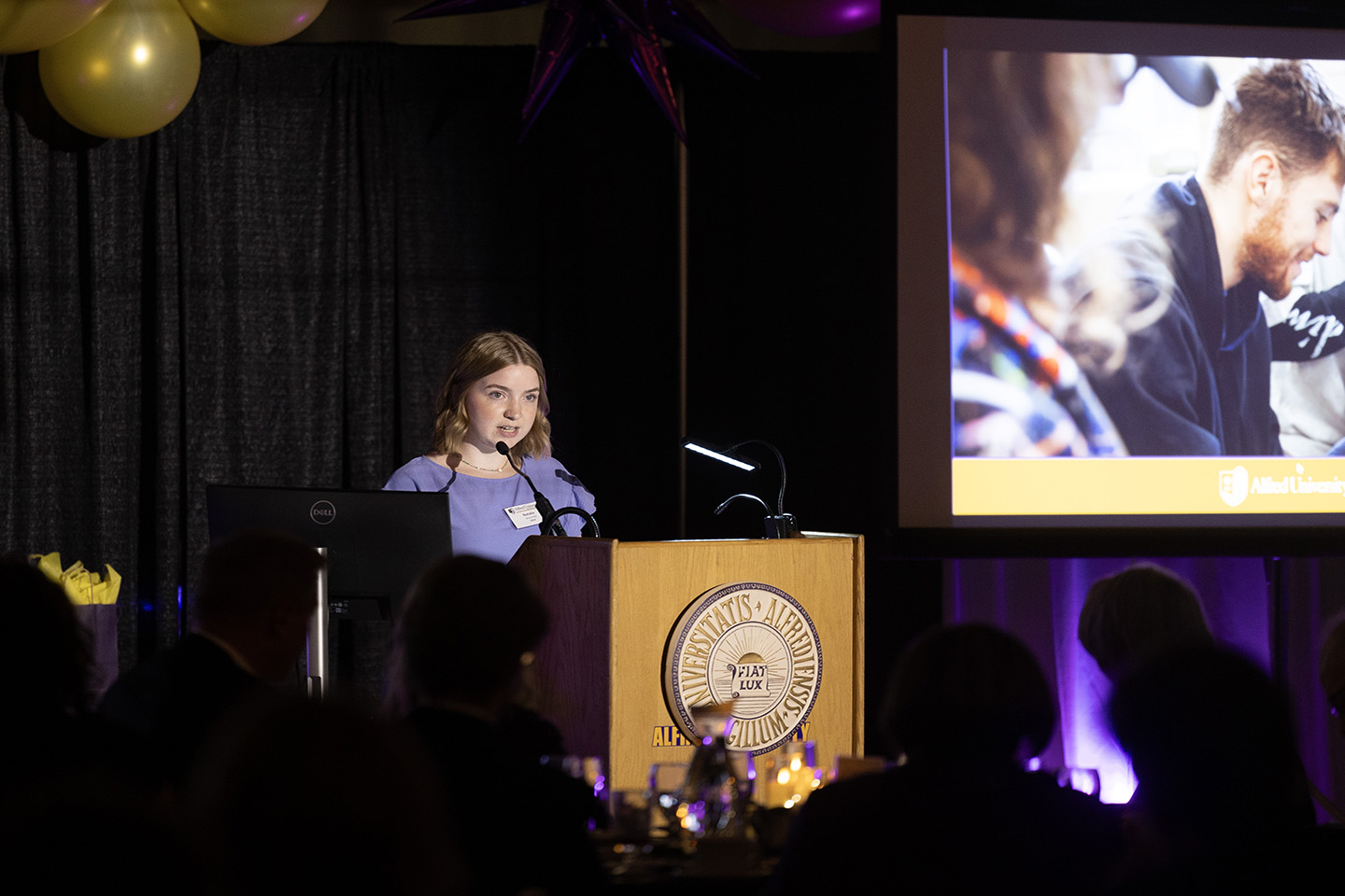 Student speaking at a podium