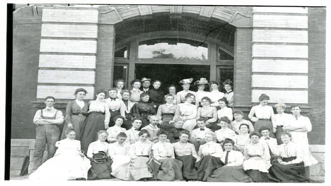 A group of students outside of a building for summer school