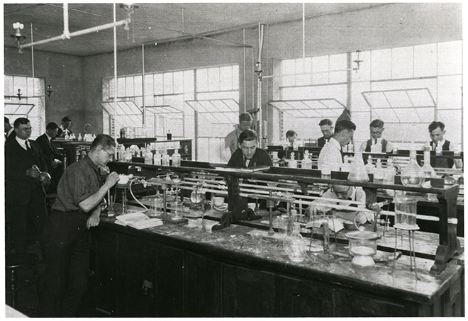Black and white photo of students in a lab