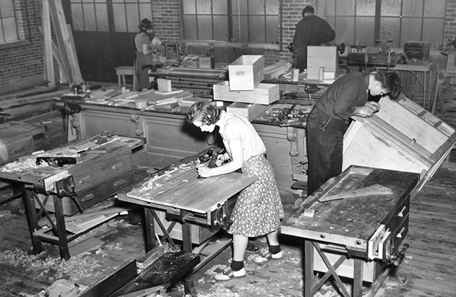 Black and white photo of students working in a lab