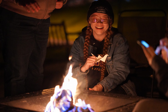 Student by a campfire