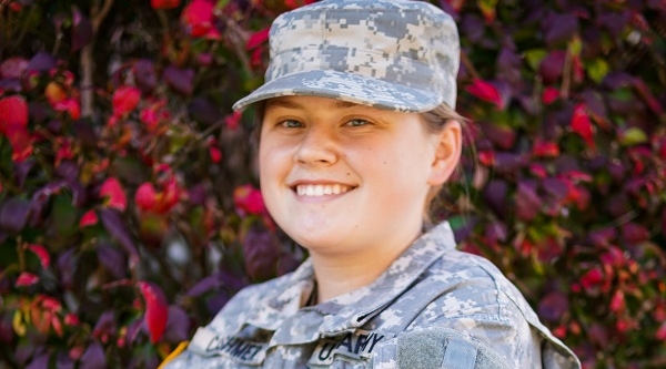 student posing and smiling in military uniform 
