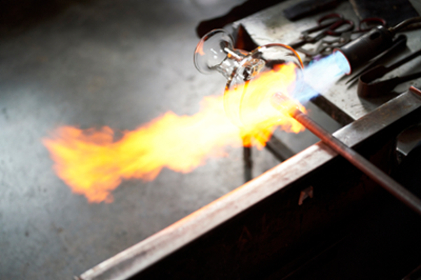 close up image of live fire from a torch heating glass