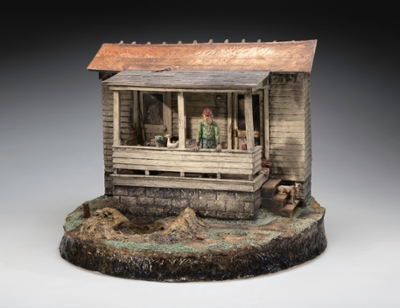 Image caption: Jack Earl (1934-2023), It's About Time, 1983, ceramic, painted, 16 3/4 x 21 x 17 1/2 inches, Gift of Crown Equipment Corporation, ACAM 2023.21, photo by Brian Oglesbee   Ceramic sculpture of an old farm house featuring a male character on the porch looking at where his yard has been dug up to fix a broken pipe. The porch is a bit cluttered with miscellaneous items and a dog is sitting on the steps.
